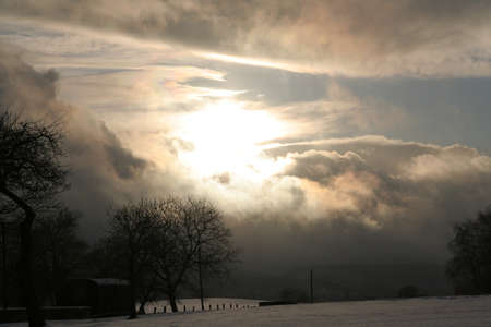 a cloudy and sunny winter landscapeの写真素材