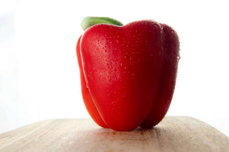 Fresh red pepper on a wooden boardの写真素材