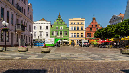 GUESTROW, MECKLENBURG-WESTERN POMERANIA, GERMANY - market place of Guestrow with town hall, restaurant and other historic buildingsのeditorial素材