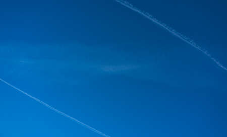 blue sky with condensation trails