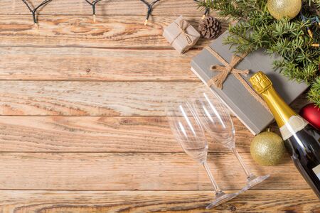 Christmas composition. Christmas gift. christmas ball. pine cones. fir branches on wooden background.top view.の写真素材