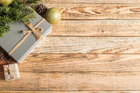 Christmas composition. Christmas gift. christmas ball. pine cones. fir branches on wooden background.top view.の写真素材