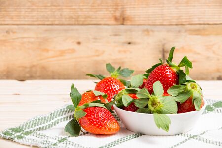 Group ripe red strawberry on wooden tableの写真素材