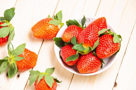 Group ripe red strawberry on wooden tableの写真素材