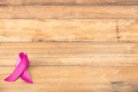 Pink ribbon for breast cancer awareness, symbolic bow color raising awareness on people living with women's breast tumor illnessの写真素材