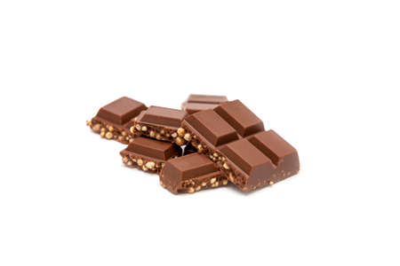 Milk chocolate pieces isolated on white backgroundの写真素材