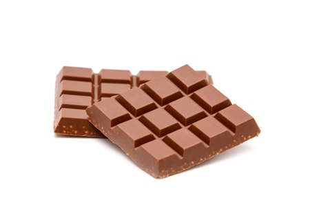 Milk chocolate pieces isolated on white backgroundの写真素材