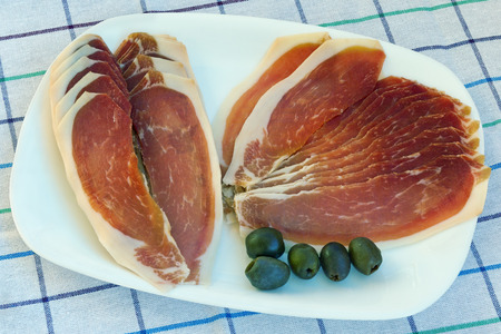 Big plate with slices of smoked ham prsut (Balkan version of prosciutto)の写真素材