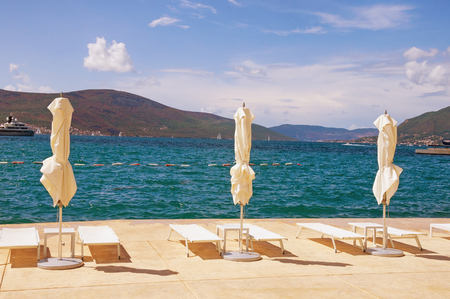 Sun umbrellas on  beach in Tivat town.  Bay of Kotor (Adriatic Sea). Montenegro, autumnの写真素材