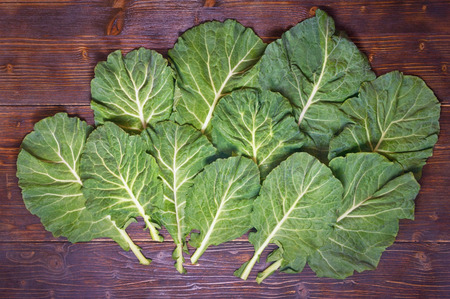 Rastan ( Collard greens, collards ) - popular leafy vegetables in Balkan cuisine. Dark rustic background, flat layの写真素材