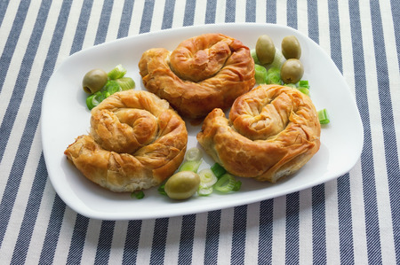 Balkan cuisine. Burek, baked filled pastries - popular national dish. Three round bureks on a white...