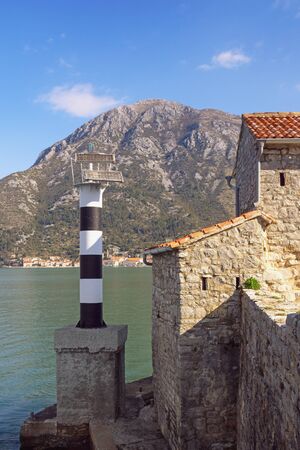 Beacon on coast of Kotor Bay. Montenegro, Adriatic Sea,  building of ancient Church of Our Lady of the Angelsの写真素材