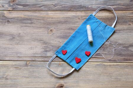 Home-made blue protective mask . Love protects, concept. Copy spaceの写真素材