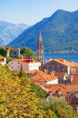 View of ancient town of Perast with bell tower of St. Nicholas Church on sunny autumn day. Montenegro, Adriatic Sea, Kotor Bayの写真素材