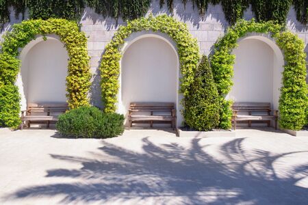 Park benches on embankment on sunny spring day. Place to relax. Montenegro, Tivat cityの写真素材