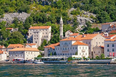 Montenegro. View of ancient town of Perast on sunny autumn day.  Bell tower of Church of Our Lady of Rosary. Adriatic Sea, Kotor Bayの写真素材