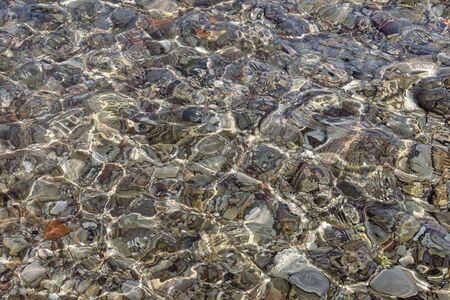 Abstract natural texture. Shallow water, stone beachの写真素材