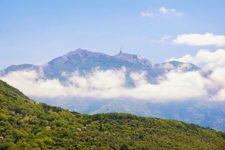 Picturesque mountain range. Montenegro, Dinaric Alps. View of peaks of Lovcen mountain from Tivat city on sunny spring dayの写真素材