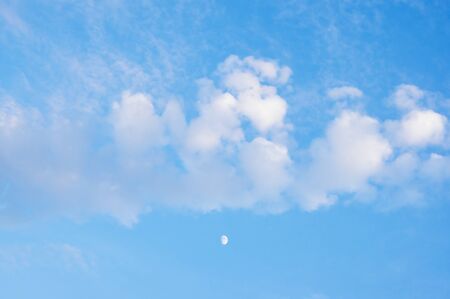 White clouds and moon in blue sky, background. Cirrocumulus cloudsの写真素材