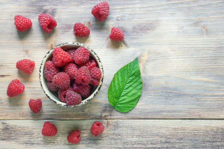 Red-fruited raspberries.  Raspberry fruits on rustic table. Flat lay. Free space for textの写真素材