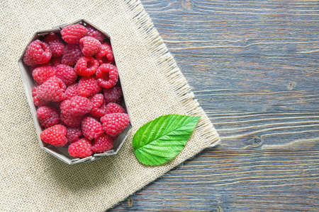 Red-fruited raspberries.  Ripe fresh raspberry fruits on rustic table. Flat lay. Free space for textの写真素材
