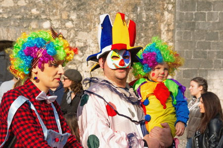 Kotor / Montenegro - March 03 2019: Traditional Winter Kotor Carnival.  Participants of Carnival against ancient walls of Old Town of Kotor . Family of clownsのeditorial素材