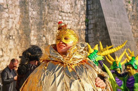 Kotor / Montenegro - March 03 2019: Traditional Winter Kotor Carnival.  Carnival participants, Lady in a costume of candy against the background of the ancient walls of the Kotor Old Townのeditorial素材