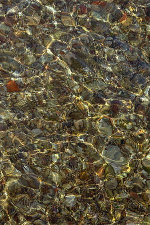 Natural colorful background, shallow water on sandy beach of Adriatic Sea on calm sunny dayの写真素材