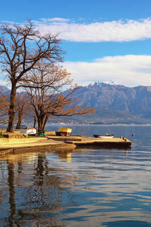 Beautiful winter Mediterranean landscape. Montenegro, Herceg Novi. View of Kotor Bay near Djenovici village and snow-capped Lovcen mountainの写真素材
