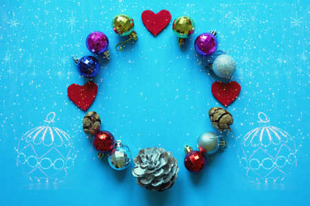 Christmas decorations. Bright colorful Christmas balls. Bright festoon illumination - double exposure. Flat lay, free space for textの写真素材