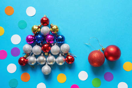 Bright colorful Christmas balls of different sizes. Christmas balls in the form of a fir-tree. Flat lay, free space for textの写真素材