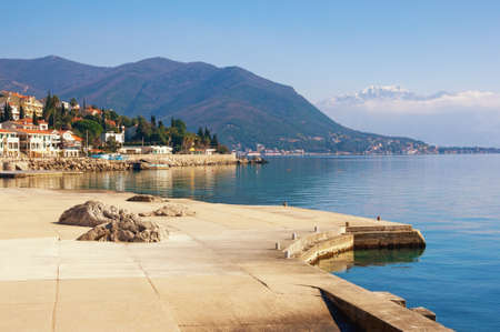 Beautiful winter Mediterranean landscape. Montenegro. View of Bay of Kotor near Herceg Novi city. Snow capped Lovcen mountains in distanceの写真素材
