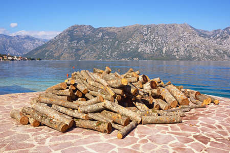 Getting ready for the winter. Beautiful sunny Mediterranean landscape, firewood for the fireplace on the coast of the bay. Montenegro, Kotor Bayの写真素材