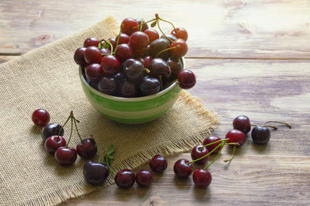 Fresh ripe cherries on rustic table. Copy spaceの写真素材