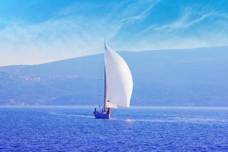 Sailing boat on water, color tinting. Montenegro, Kotor Bay. Travel concept