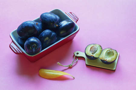 Large ripe purple plums on a pink background. Free space for textの写真素材