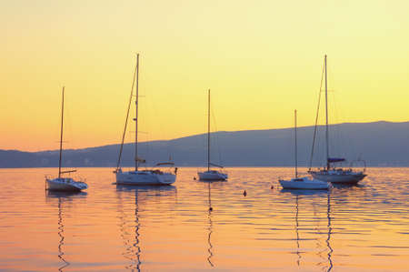 Autumn sunset with sailboats on water. Kotor Bay, Tivat, Montenegroの写真素材