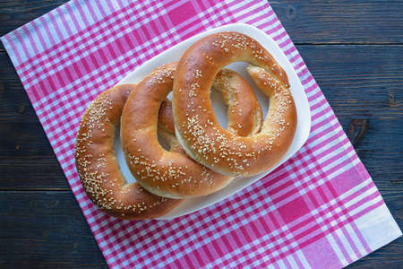 Homemade bagels on red and white checkered textile background. Flat layの写真素材
