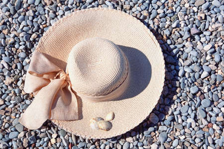 Sun hat on pebble beach. Summer and vacations conceptsの写真素材