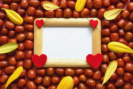 Autumn. Fresh  Jujube fruits ( Ziziphus jujuba ) and yellow autumn leaves.  Frame for textの写真素材