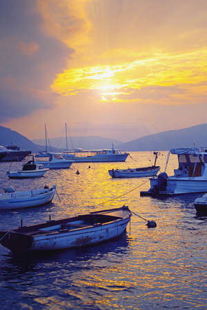 Autumn sunset. Beautiful Mediterranean landscape with boats on water.  Montenegro, Kotor Bayの写真素材