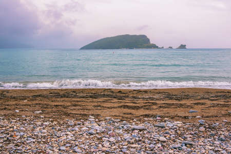 Montenegro. Coast of Adriatic Sea near Old Town of Budva. View of Sveti Nikola Island on cloudy autumn dayの写真素材