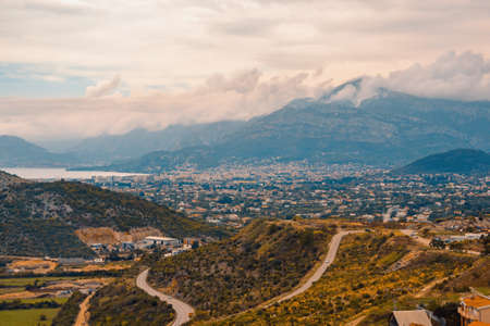 Autumn Mediterranean landscape on cloudy misty day. Autumn Balkan road trip: clouds, mountains, hills and roads. Montenegro, view of Dobra Voda townの写真素材