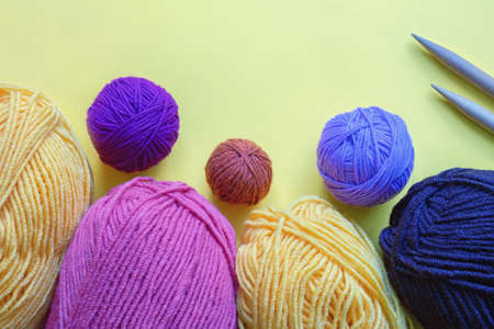 Colorful clews and skeins of wool for knitting. Hobby concept. Paper background, copy spaceの写真素材