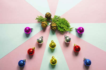 Colorful Christmas balls and green cypress tree branch with cones. Paper background. Copy spaceの写真素材