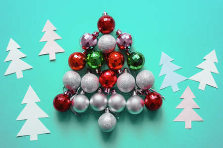 Colorful Christmas balls in the form of Christmas tree on paper background. Copy spaceの写真素材