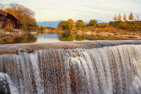 Autumn mountain landscape with river and waterfall. Cijevna river waterfall ( Montenegrin Niagara fall).  Montenegro, Podgoricaの写真素材