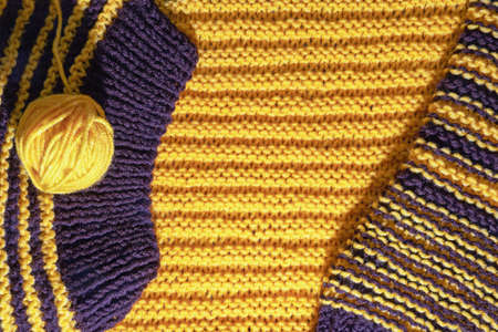 Hobbies and knitting concept. Yellow and brown knitting; homemade knitted  background. Copy spaceの写真素材