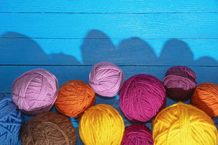 Hobbies and knitting concept.  Colorful balls of wool on  blue rustic table. Copy spaceの写真素材
