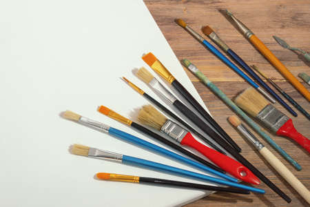 Different brushes for painting on white canvas. Free space for text or pictureの写真素材